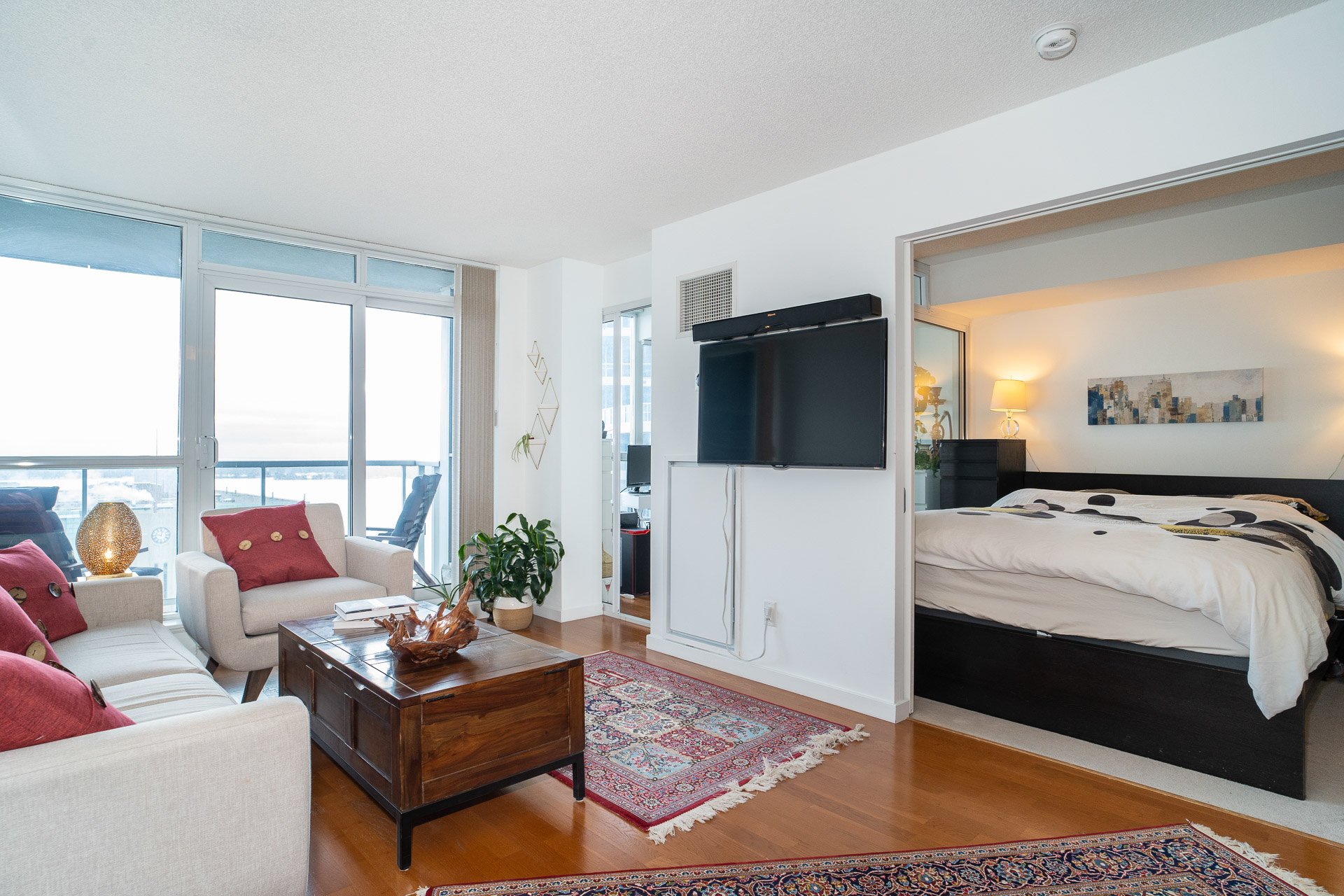 Living room with bedroom visible